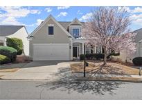 Charming home featuring a manicured lawn and flowering tree at 3805 Delfaire Trce, Cumming, GA 30040