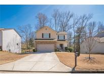 Charming two-story home featuring a two-car garage and a well-manicured front lawn at 95 Old Country Trl, Dallas, GA 30157