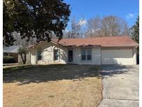 Charming single-story home with a well-maintained lawn, brick facade, and attached garage at 3260 Valley Bend Rd, Atlanta, GA 30349