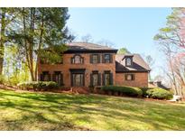 Charming brick home with manicured lawn and dark shutters at 1435 Jay Ct, Snellville, GA 30078