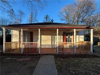 Cozy single-story home featuring a front porch with red accents, perfect for enjoying the outdoors at 18 Laurel St, Covington, GA 30014