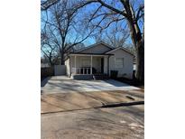 Charming home featuring a welcoming front porch and an expansive concrete driveway at 109 Thirkield Se Ave, Atlanta, GA 30315