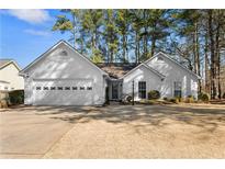 Charming single-story home featuring a two-car garage and well-maintained front yard at 4860 Roswell Mill Dr, Alpharetta, GA 30022