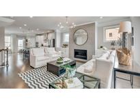 Bright living room featuring a fireplace, modern chandelier, and a stylish chevron rug at 1696 Lansmere Sw St, Marietta, GA 30008