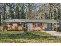 Charming single-story brick home featuring a covered carport, well-maintained lawn, and traditional design at 3007 Knightsbridge Nw Rd, Kennesaw, GA 30144