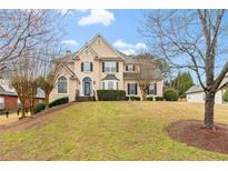 Charming two-story home with well-manicured lawn and beautiful landscaping at 1035 Eagles Brooke Dr, Locust Grove, GA 30248