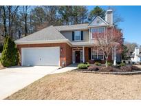 Charming two-story home featuring a brick facade, attached garage, and beautifully landscaped front yard at 3952 Rhyne Way, Smyrna, GA 30082