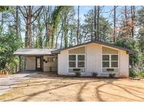 Charming single-story home with a carport and well-maintained landscaping at 2542 Warwick Ne Cir, Atlanta, GA 30345