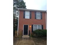 Brick townhouse with a black front door and black shutters on the windows at 2649 Fieldstone View Se Ln, Conyers, GA 30013