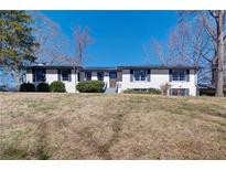 Charming one-story brick home with a well-maintained front yard and mature trees at 1891 Donald Dr, Marietta, GA 30062