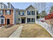 Charming two-story home with a well-manicured lawn and inviting front porch and attractive architectural details at 1284 Warsaw Rd, Roswell, GA 30076