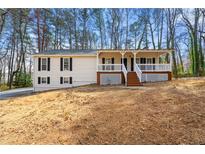 Charming ranch-style home with a welcoming front porch and well-maintained landscaping at 3260 Brandywine Nw Pl, Marietta, GA 30064