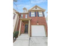 Charming two-story brick home with an attached garage, and a welcoming front door at 3677 Utoy Sw Dr, Atlanta, GA 30331
