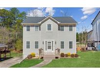 Charming two-story home with gray siding, new roof, and a well-manicured lawn at 972 Oakley Ln, Sugar Hill, GA 30518