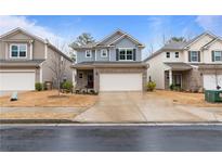 Charming two-story home featuring brick and blue siding, and a well-manicured lawn at 5915 Pinnacle View Rd, Cumming, GA 30040