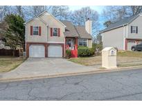 Charming two-story home with red shutters, two car garage and landscaped yard at 4096 Mistymorn Ln, Powder Springs, GA 30127