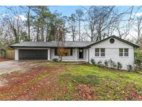 Charming renovated brick home with an attached garage and manicured lawn at 3367 Spring Meadow Ct, Tucker, GA 30084