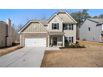 Charming two-story home featuring stone accents, neutral siding, and an attached two-car garage at 461 Charleston Pl, Villa Rica, GA 30180