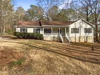 Charming single-story home with a welcoming front porch and well-maintained landscaping at 521 Country Lake Dr, Mcdonough, GA 30252