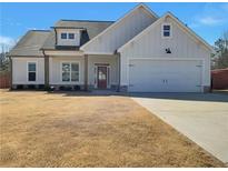 Charming home featuring a well-manicured lawn, attached garage, and a classic craftsman-style exterior at 92 Harmony Woods Dr, Dallas, GA 30157