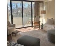 Bright living room with large sliding glass doors and comfortable seating at 3530 Piedmont Ne Rd # 3I, Atlanta, GA 30305