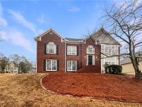 Two story brick home with black trim and mulch yard in a residential area at 4905 Ascot Nw Blf, Acworth, GA 30102