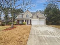 Charming two-story home with a two-car garage and a welcoming front porch in a tree-filled neighborhood at 2208 Howell Farms Nw Pt, Acworth, GA 30101