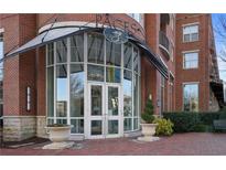 Beautiful brick building entrance featuring double glass doors and elegant landscaping at 325 E Paces Ferry Ne Rd # 2005, Atlanta, GA 30305