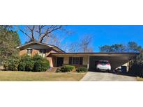 Charming single-story brick home with a convenient carport and well-maintained front yard at 4870 Welcome All Sw Rd, Atlanta, GA 30349