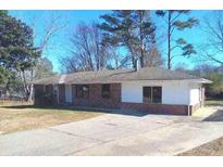 Charming single-story brick home with a spacious driveway and well-maintained lawn at 6258 Mount Zion Blvd, Morrow, GA 30260