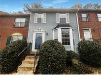 Charming two-story townhome with blue siding, bay window, and well-maintained front yard at 6420 Wedgeview Dr, Tucker, GA 30084