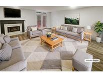 Bright, staged living room with a fireplace, modern furniture, and access to an outdoor area at 6420 Wedgeview Dr, Tucker, GA 30084