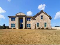 Stately two-story brick home with arched entryway and manicured front lawn at 3308 Steeple Chase Sw Way, Conyers, GA 30094