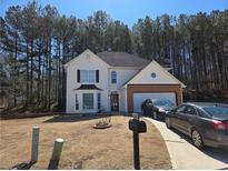 Charming two-story home with a well-maintained lawn, two-car garage, and driveway parking at 3578 Willow Spring Ct, Decatur, GA 30034