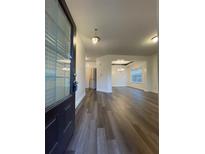 Inviting entrance with dark brown door, hardwood floors, and views into the dining room at 5928 Cobblestone Creek Cir, Mableton, GA 30126