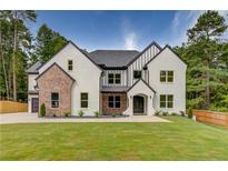 Stunning two-story home featuring a modern design with a well-manicured lawn at 1090 Larosa Dr, Lawrenceville, GA 30043