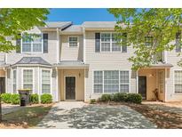 Inviting two-story townhouse with neutral siding and a well-kept front yard, perfect for comfortable living at 2454 Brianna Dr, Hampton, GA 30228