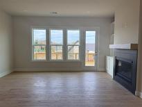 Bright living room features hardwood floors, a fireplace, and large windows with natural light at 2445 Red Maple Xing Se, Smyrna, GA 30080