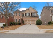 Charming two-story brick home with a well-manicured lawn and a two-car garage at 5720 Stow Dr, Tucker, GA 30084