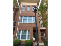 Lovely brick townhome with large windows and a vintage style lamp post at entrance at 745 Fountainhead Ne Ln # 130, Atlanta, GA 30324