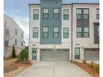 Charming townhome showcasing a modern facade with a two-car garage and landscaped entrance at 2655 Sarah Carlin Ct, Norcross, GA 30071