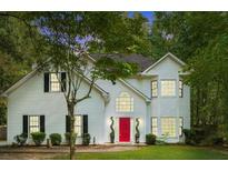 Charming two-story home with white siding, black shutters, a bright red front door, and lush green lawn at 76 Barrington Farms Pkwy, Sharpsburg, GA 30277