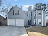 Inviting two-story home featuring a two-car garage, gray siding, and a well-maintained lawn at 4152 Coconut Nw Grv, Acworth, GA 30101