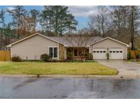 Charming single-story home featuring a well-maintained lawn, attached two-car garage, and inviting curb appeal at 106 Lanyard Bnd, Peachtree City, GA 30269