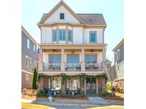 Charming two-story home with a covered porch, columns, and landscaped front yard at 219 Dawson Dr, Woodstock, GA 30188