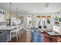 Bright living space with a kitchen bar, a fireplace and sophisticated decorations at 219 Dawson Dr, Woodstock, GA 30188