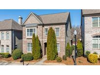 Beautiful brick home with manicured landscaping and mature trees at 4309 Elliott Way, Smyrna, GA 30082