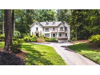 Stunning two-story home with lush landscaping, manicured lawn, and inviting driveway at 1165 E Beechwood Nw Dr, Atlanta, GA 30327