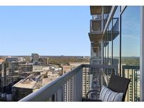 Relaxing condo balcony with chair overlooking the city skyline and tree line at 3324 Peachtree Rd # 2717, Atlanta, GA 30326