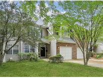 Charming two-story home with well-maintained lawn and attached two car garage, nestled among mature trees at 63 Fulton Se St, Atlanta, GA 30312